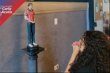 Jovem reza diante da imagem de Carlo Acutis na paróquia que será dedicada a ele