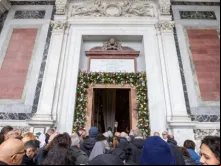 Peregrinos cruzam a porta santa da basílica de São Paulo Fora dos Muros, em Roma.