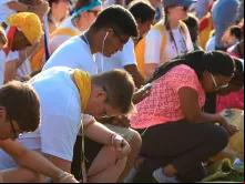 Jovens rezando na Jornada Mundial da Juventude (JMJ) Cracóvia 2016